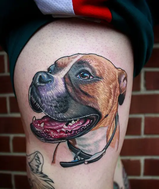realistic smiling face of Boxer dog tattoo on thigh
