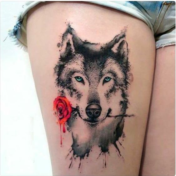 black and white Husky with blue eyes and holding a red rose in its mouth tattoo on thigh