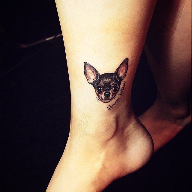 face of black Chihuahua tattoo on the wrist