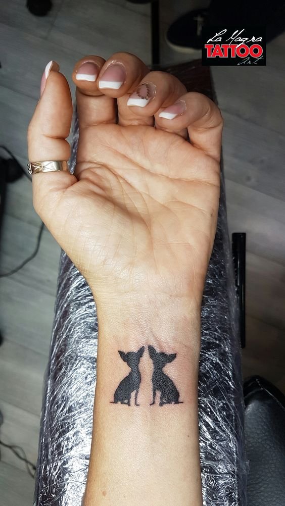 all black two Chihuahuas tattoo on the wrist