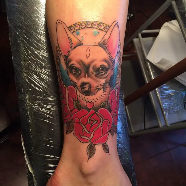 Chihuahua with red flowers tattoo on the leg