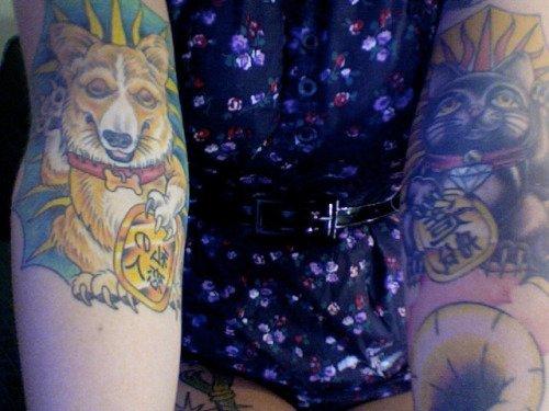 a fortune teller corgi tattoo on the arm of a woman