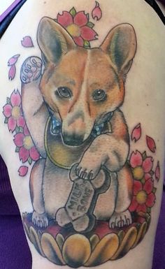 animated corgi with red flowers tattoo on the shoulder
