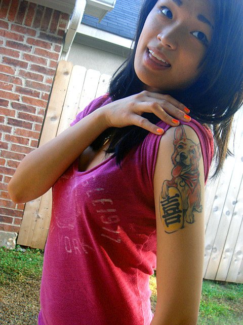 a woman with a corgi tattoo on her shoulder