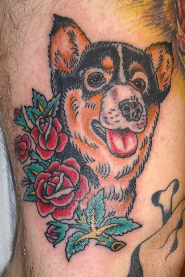 artistic corgi with flowers and leaves tattoo on the leg