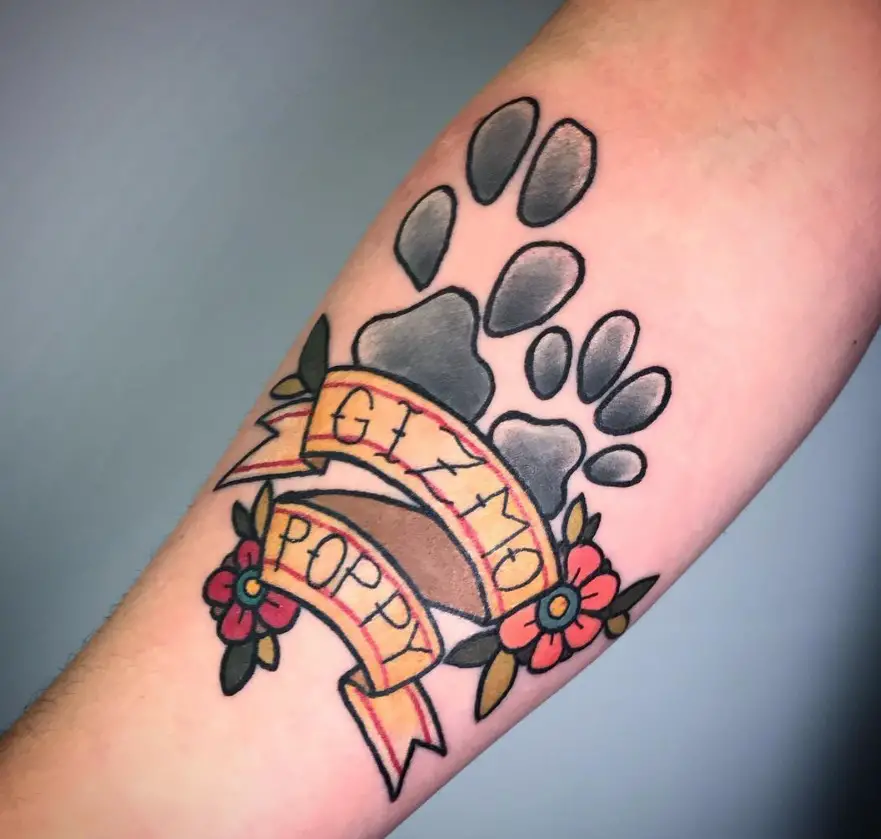 gray paw prints with name Gizmo poppy tattoo on the forearm