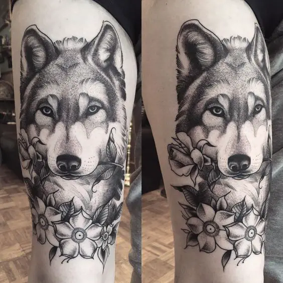 black and gray Husky with a picked flower in its mouth tattoo on thigh