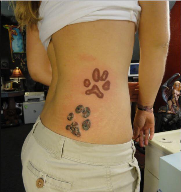 two paw prints tattoo on the side of the girls body