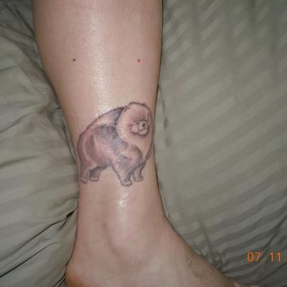 black and gray standing Pomeranian Tattoo on the ankle