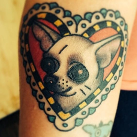 animated Chihuahua inside a heart frame tattoo on the forearm