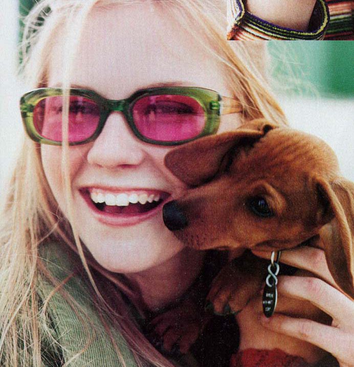 Kirsten Dunst holding her Dachshund close to her cheeks