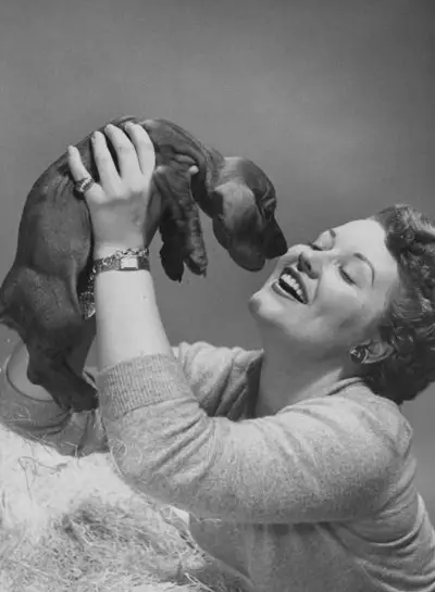 black and white photo of Patti Page holding up her Dachshund