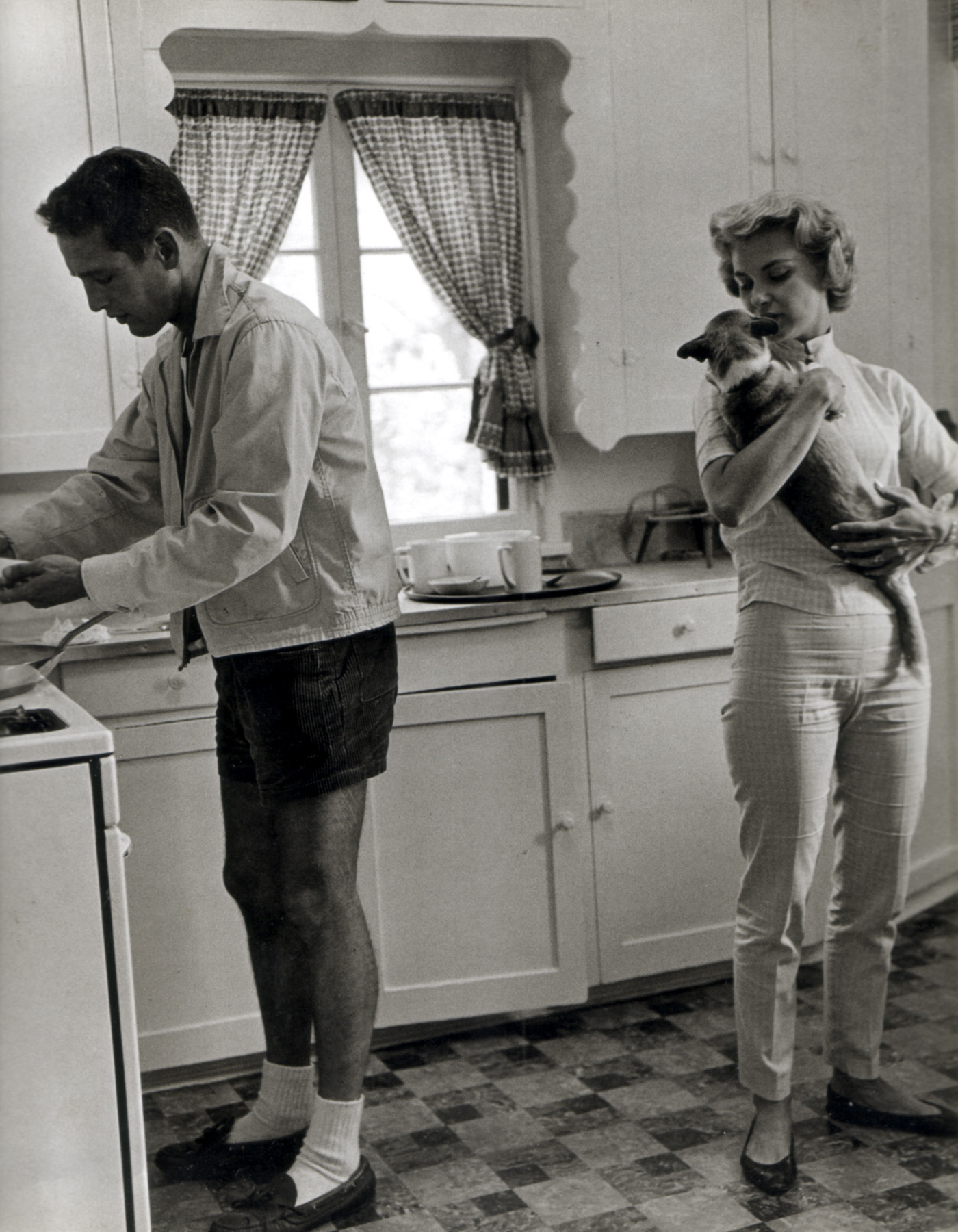 Paul Newman & Joanne Woodward in the kitchen with their Dachshund 