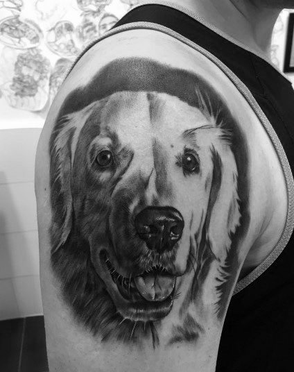 black and whit photo of 3D smiling Golden Retriever Tattoo on the shoulder