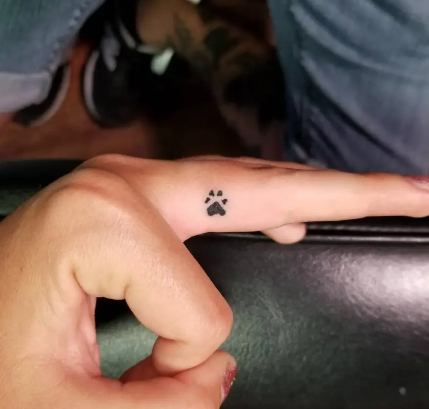 minimalist paw print tattoo on fingers