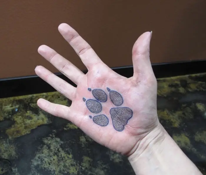 paw print tattoo on the palm of hands