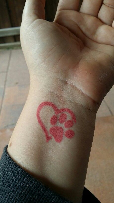 red heart and paw print tattoo on wrist