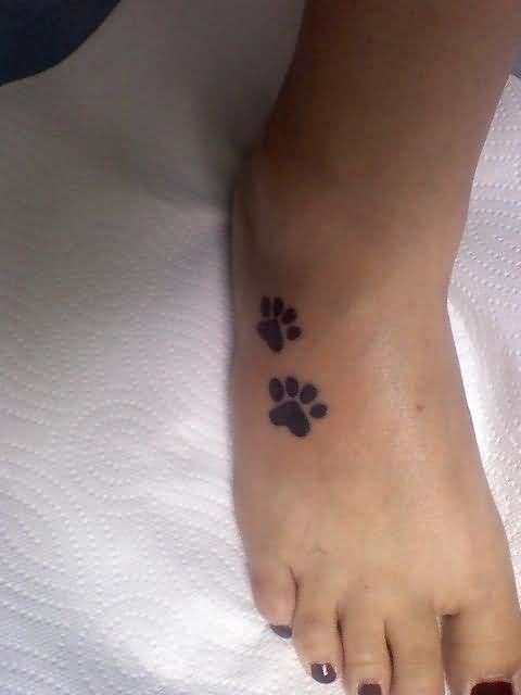 two paw prints tattoo on feet