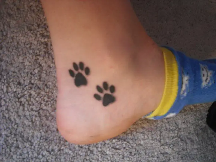 two paw prints tattoo on the ankle