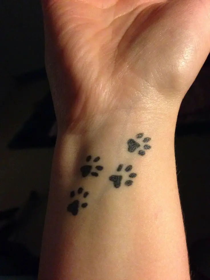 small four paw prints tattoo on wrist