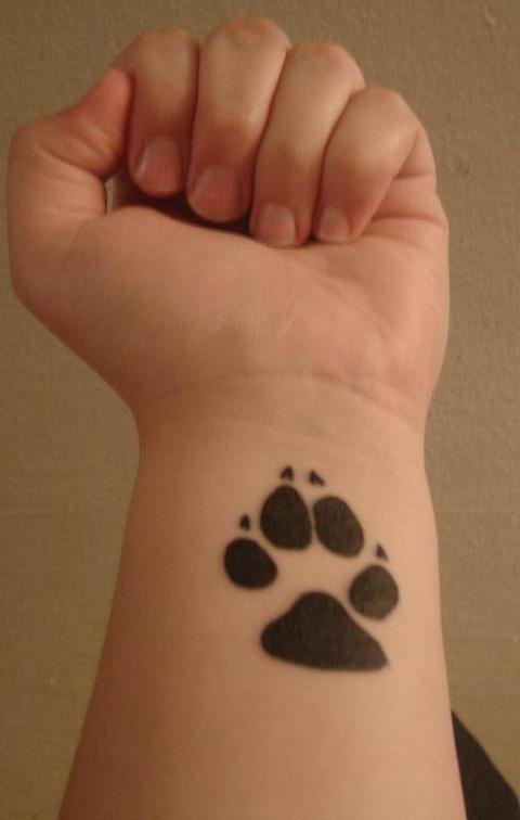 paw print tattoo on wrist