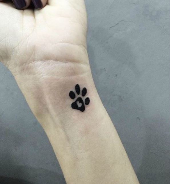 small paw print tattoo on wrist