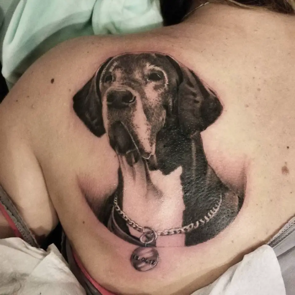 3D looking up face of a Great Dane tattoo on the back