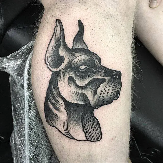 black and grey side view face of a Great Dane tattoo on the leg