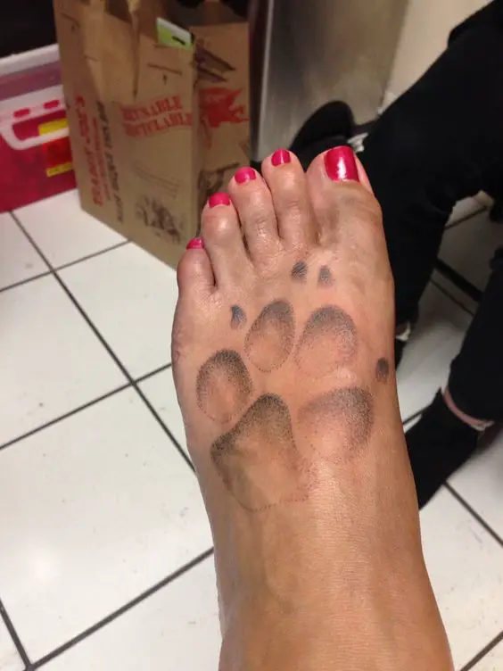 Paw print tattoo on foot
