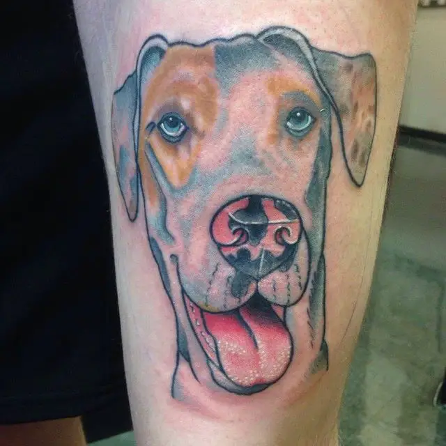 realistic face of a Great Dane with its tongue out tattoo on the thigh