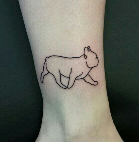 outline of a walking English Bulldog tattoo on the ankle