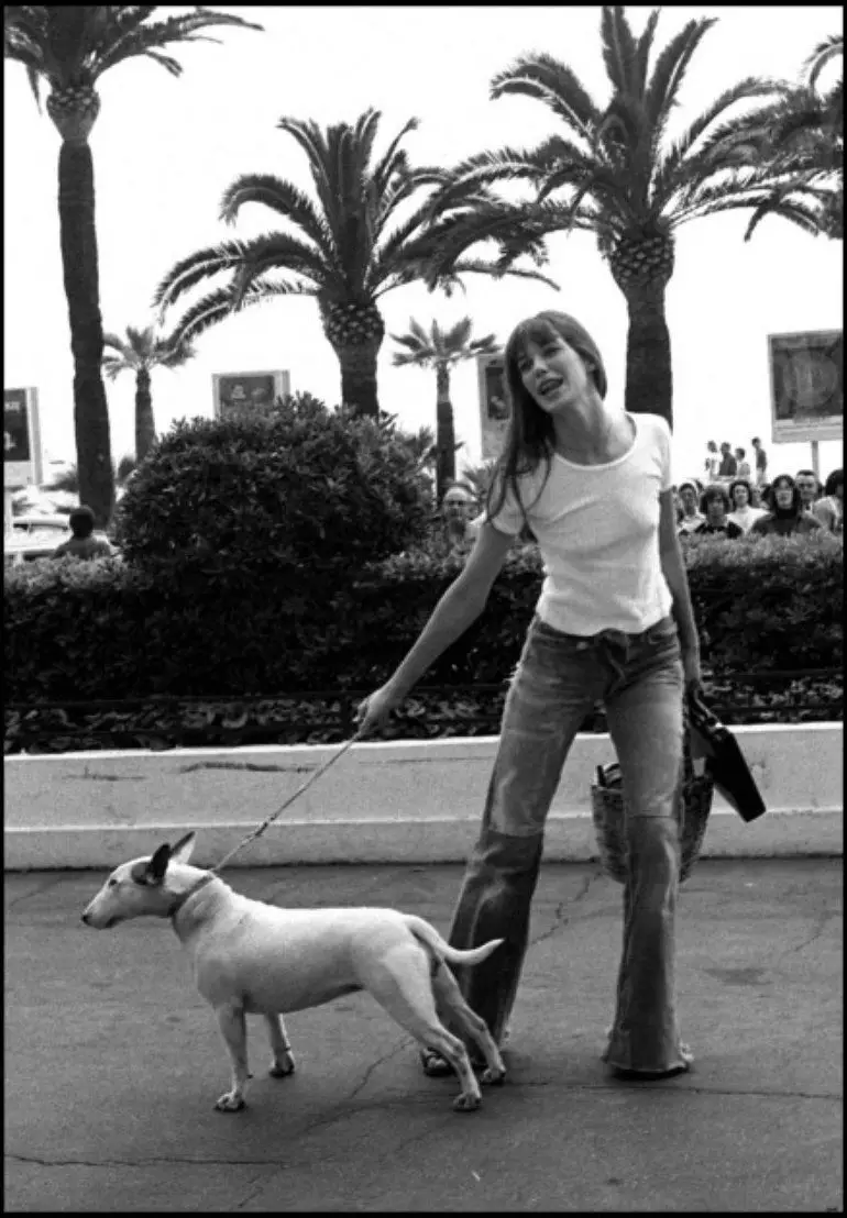 black and white photo of Jane Birkin in the street with her English Bull Terrier