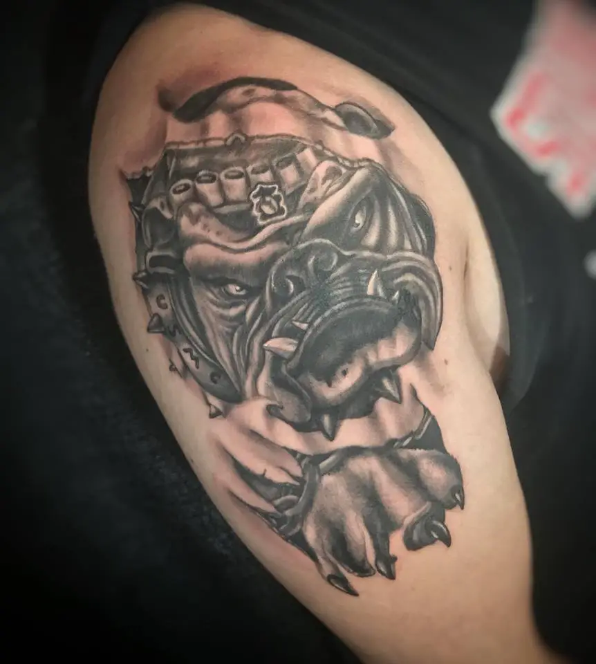English Bulldog monster with sharp teeth, nails and furious eyes tattoo on the shoulder