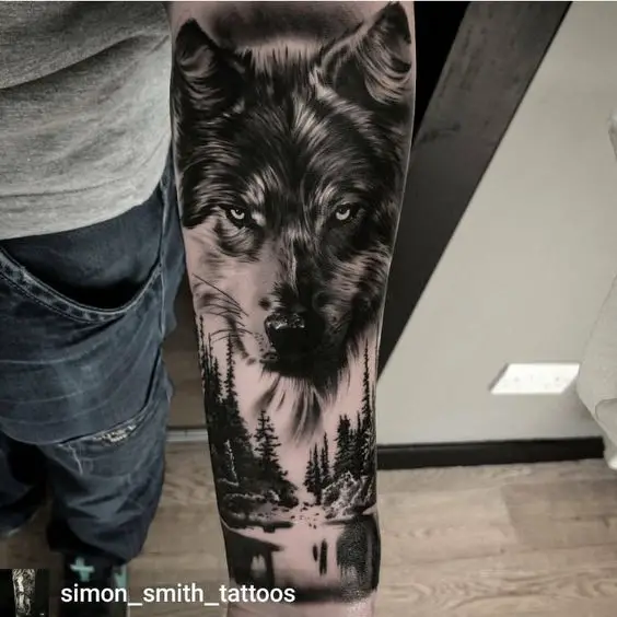 fierce black and gray face of a Husky with pine trees in the lake underneath it tattoo on the forearm