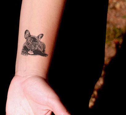 lying down French Bulldog Tattoo on the wrist