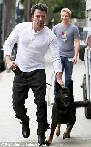 Ben Affleck grabbing his German Shepherd in its collar