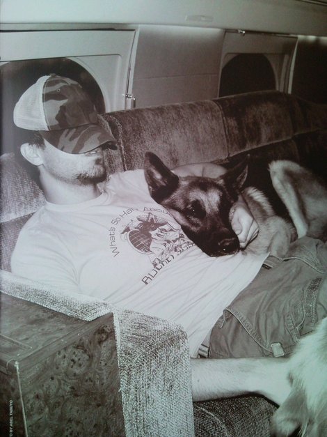 Enrique Iglesias inside the car sleeping while its German Shepherd dog is beside him