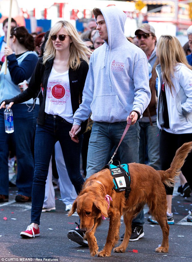 Emma Stone and Andrew Garfield in a crowd with their Golden Retriever
