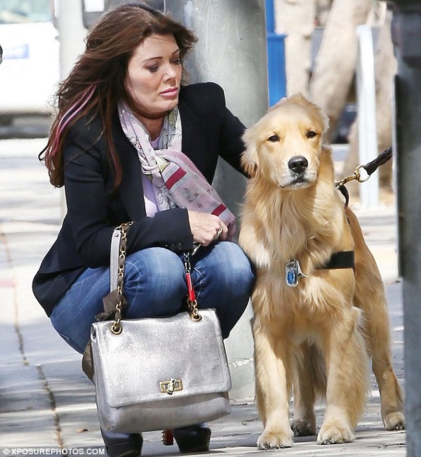 Lisa Vanderpump in the street with her Golden Retriever