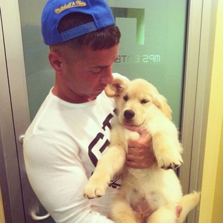 Mike Sorrentino carrying his Golden Retriever