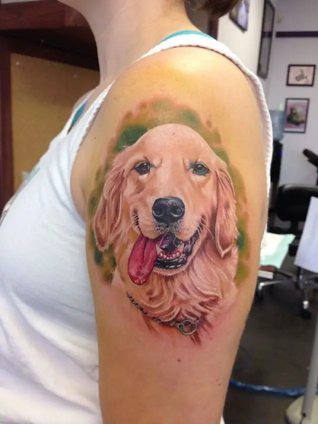 realistic Golden Retriever Tattoo smiling with its tongue out and in green shadow tattoo on the shoulder