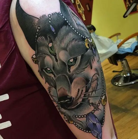 royalty black and brown Husky with gems around its head and neck tattoo on the shoulder