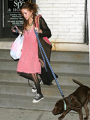 Mary Kate Olsen going down the stairs with her Labrador Retriever named Luca