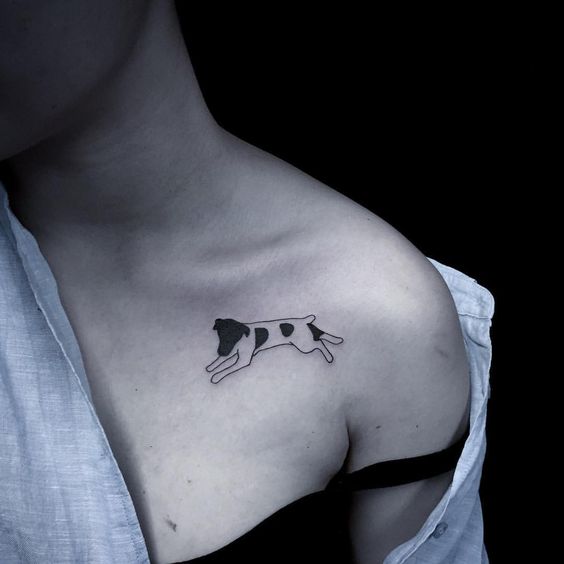 minimalist lying down Jack Russell Terrier Tattoo on the chest