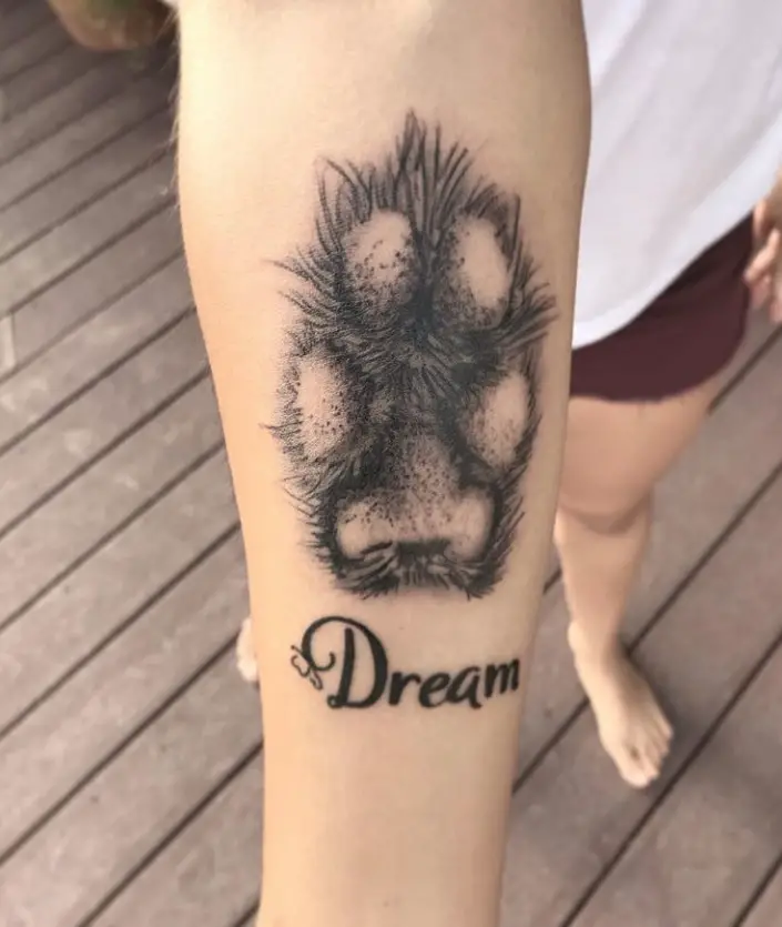 paw print with name tattoo on wirist