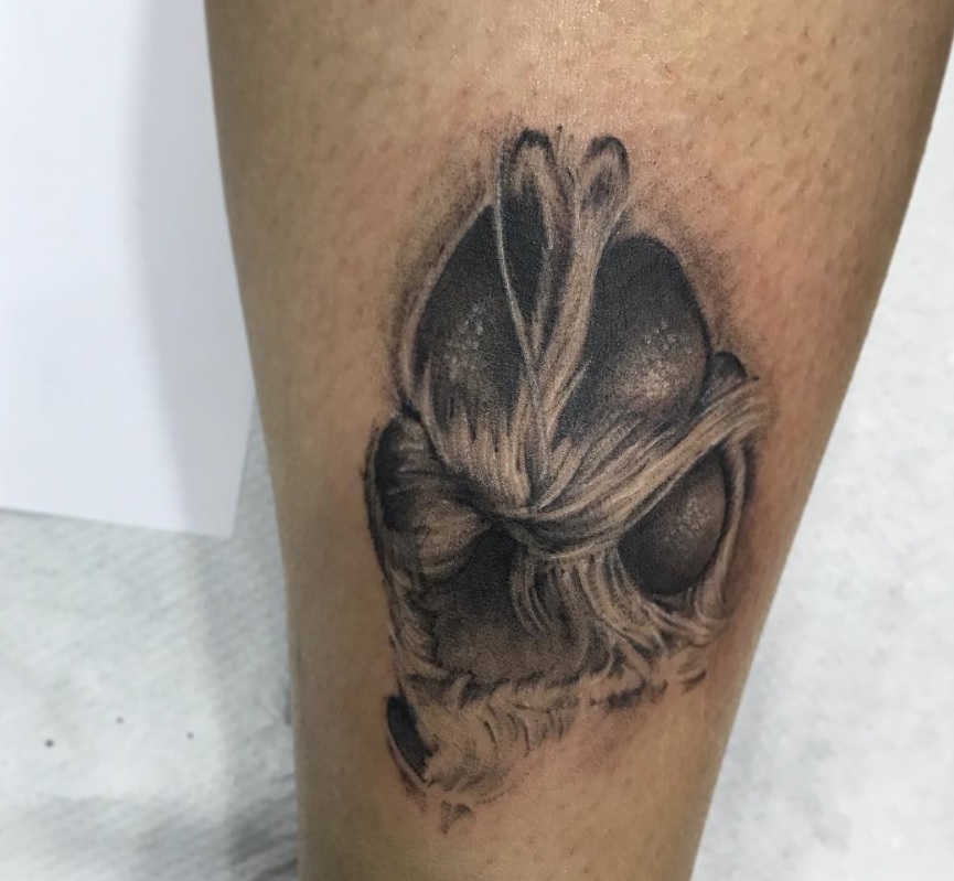 realistic black and gray paw tattoo on the leg