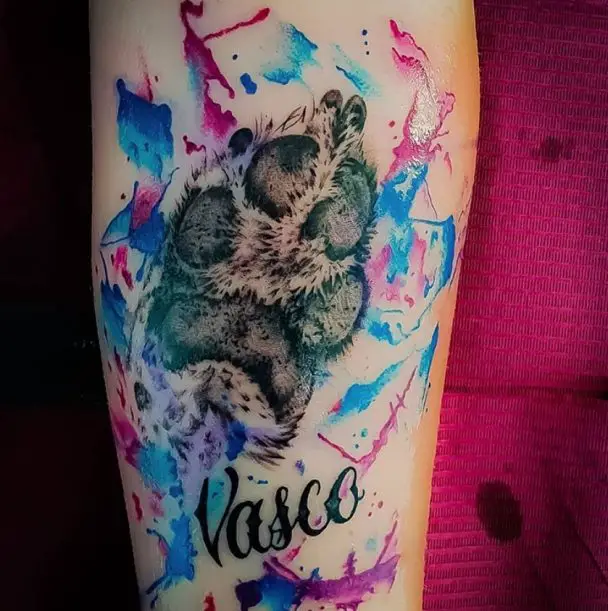 paw print tattoo with colorful watercolor and name tattoo on arms