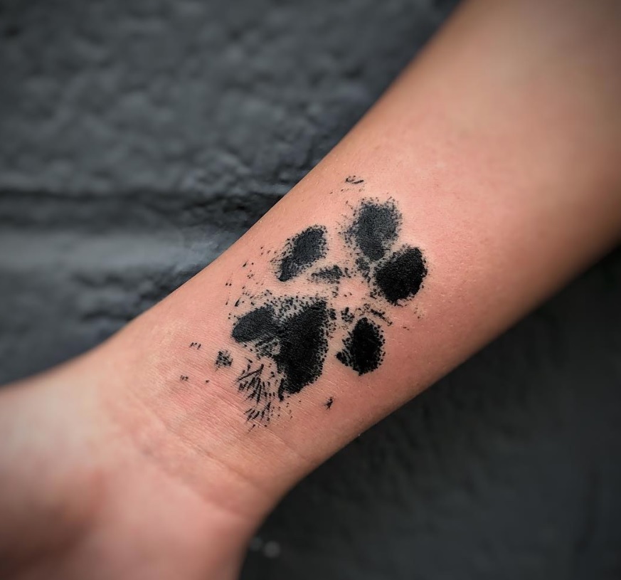 paw print tattoo on wrist