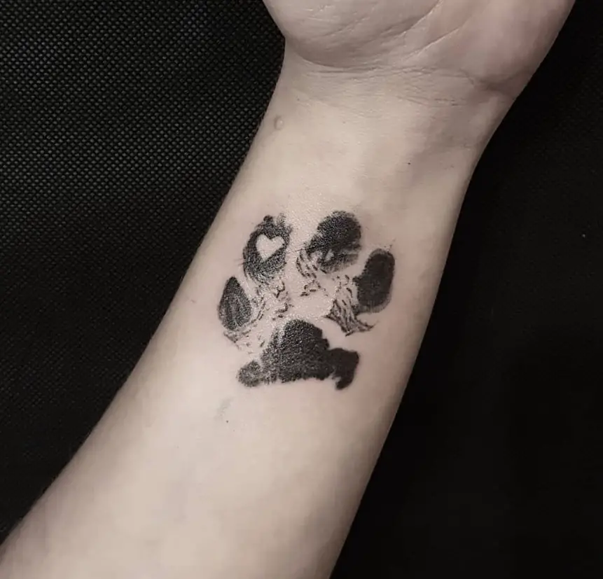 paw print with heart tattoo on wrist