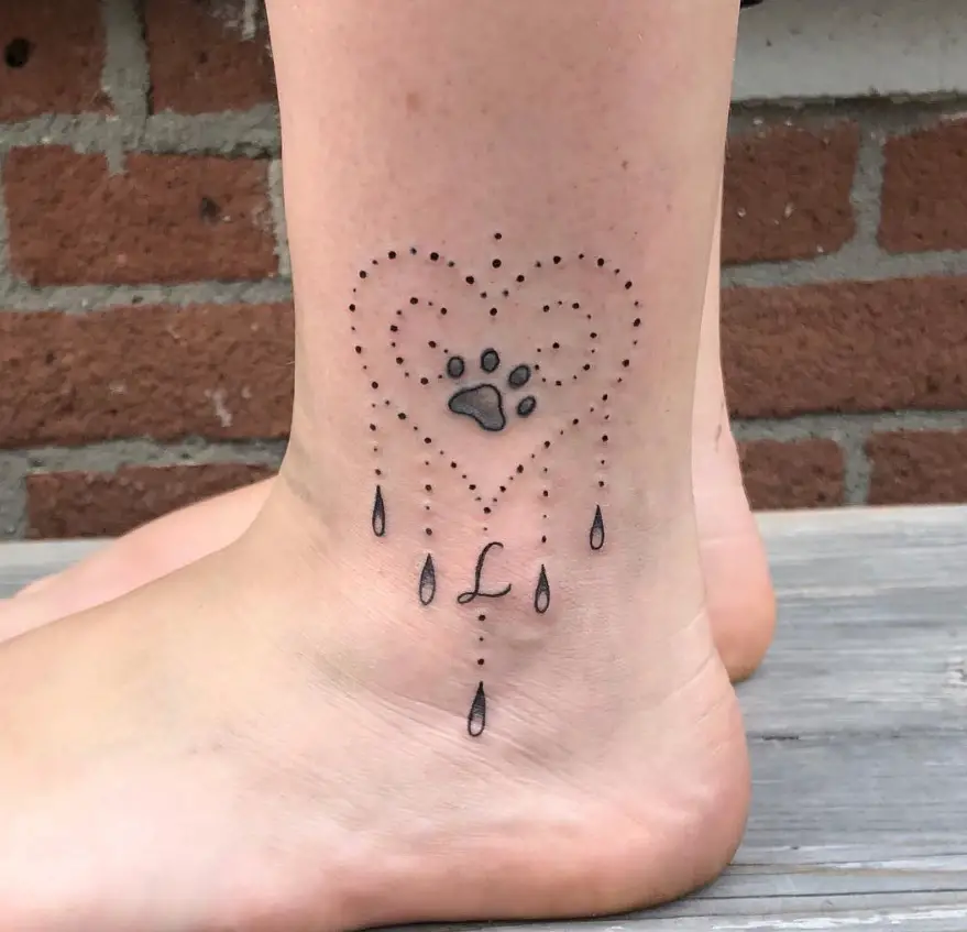 heart shaped dots and paw print inside tattoo on the ankle